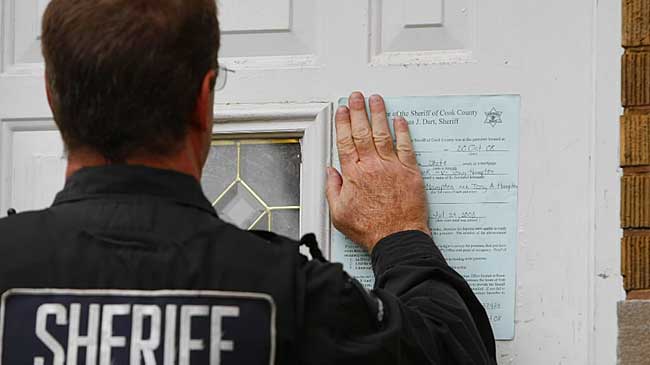 Sheriff Posting Eviction Notice in Fron Door