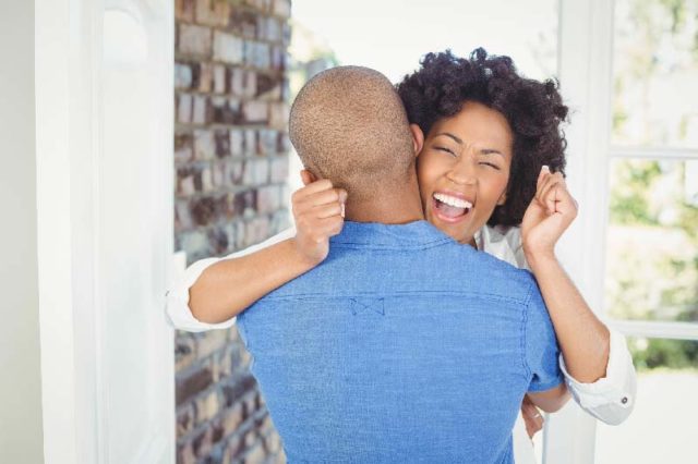 Couple cheering while embracing