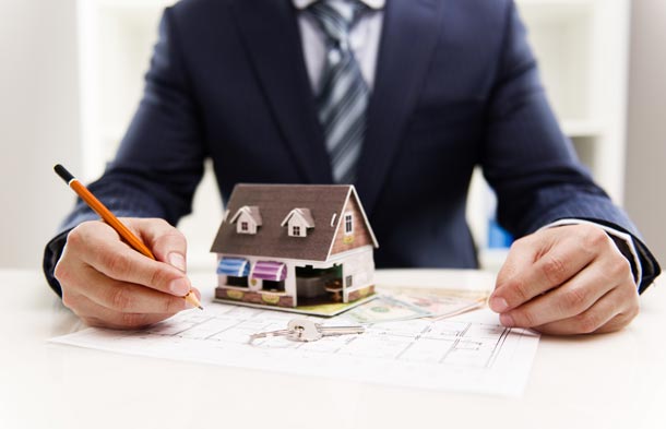 Man Filling Out House Selling Paperwork